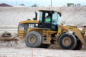 Marina Araujo on bulldozer at construction site.