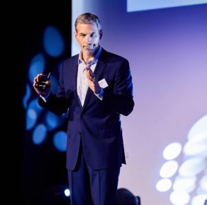 Tom Vander Ark speaks on stage in Korea.