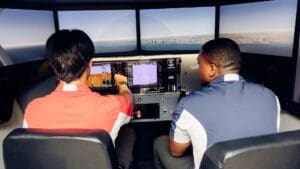 Broward College student pilot in flight simulator with instructor