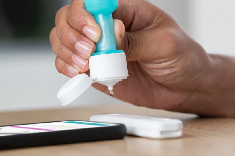 Ellume-COVID-19-Home-Test_Adult-drops-into-analyzer-scaled