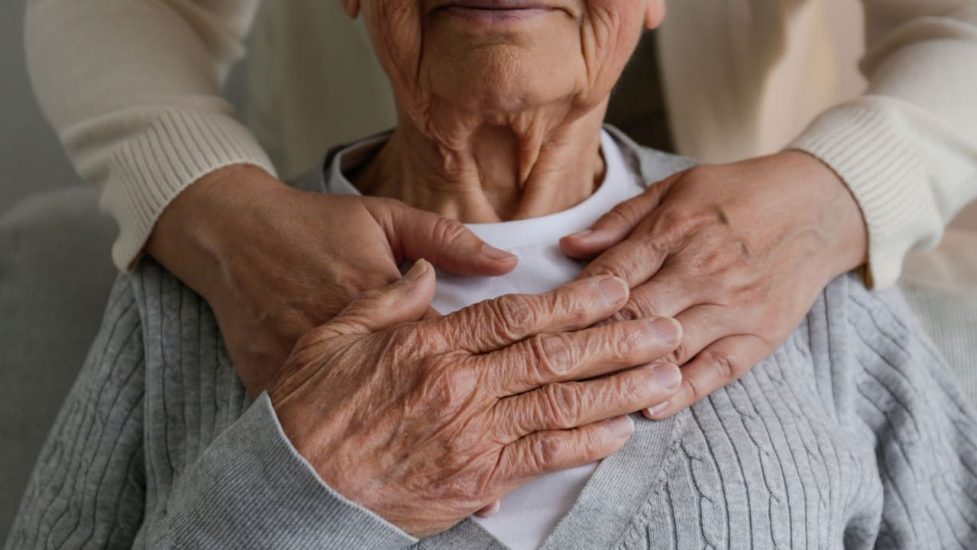 Family caregiver hugging woman