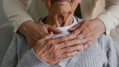 Family caregiver hugging woman