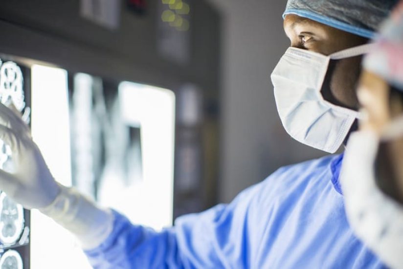 Mid adult man examining patients MRI