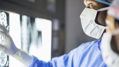 Mid adult man examining patients MRI
