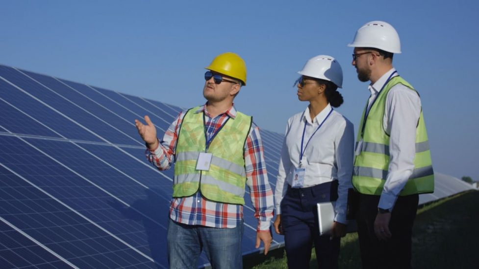 three people solar panels