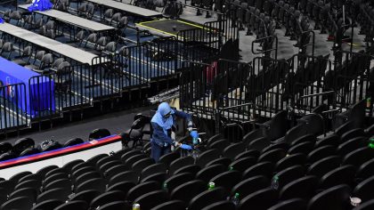 worker-cleaning-arena-crossing-broad